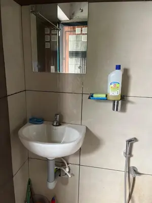 a bathroom with a sink and a mirror at Tulips villa in Mānantoddy