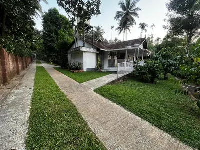 a house in the middle of a yard at Avocado Orchards - Villa in Kenichira