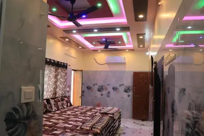 a bedroom with a bed and lights on the ceiling at Happy Holidays Cottage in Wodapatti