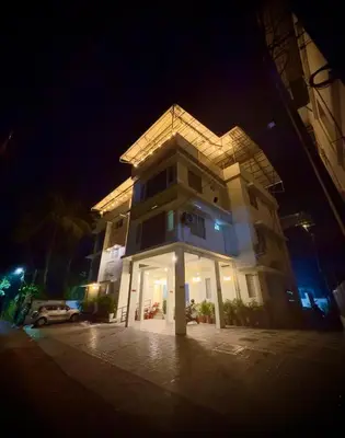 a building at night with a car parked in front at Tokyoz Inn Calicut in Kunnamangalam