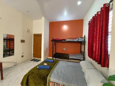 a bedroom with a bed and a couch in it at Galasy in Narasimharaja Puram