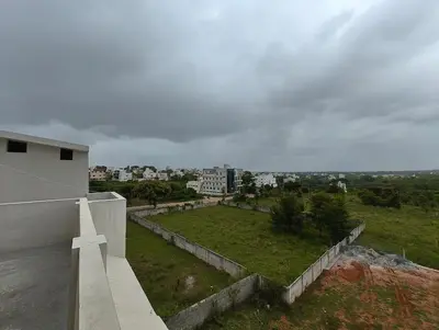 a cross on the side of a white building at Galasy in Narasimharaja Puram