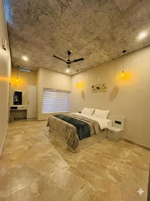 a bedroom with a large bed with a stone ceiling at Hira Homestay Wayanad in Pinangode