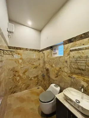 a bathroom with a toilet and a sink at Hira Homestay Wayanad in Pinangode