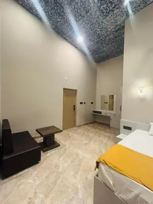 a bedroom with a bed and a table in a room at Hira Homestay Wayanad in Pinangode
