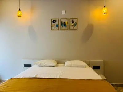 a bedroom with a bed with two pillows on it at Hira Homestay Wayanad in Pinangode