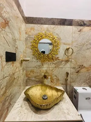 a bathroom with a sink with a mirror at Hira Homestay Wayanad in Pinangode