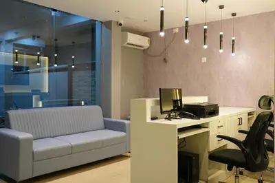 an office with a couch and a desk with a computer at Elite Group Mysore in Mysore