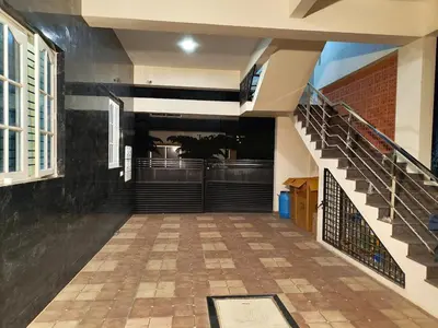a hallway of a building with a staircase and a stair case at Namasv 2BHK AC House in Narasimharaja Puram