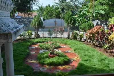 a garden with plants in the middle of a yard at Brindavanam HomeStay Salem in Salem
