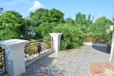 a patio with a railing and a table on a patio at Brindavanam HomeStay Salem in Salem