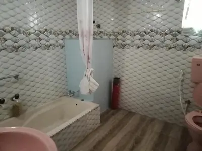 a bathroom with a tub and a toilet and a sink at Avichala in Mysore