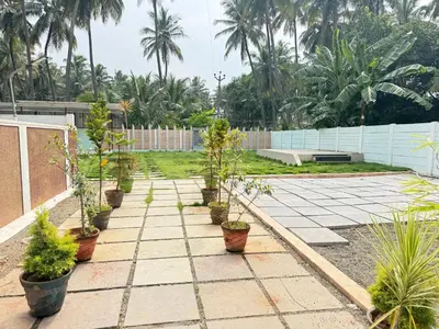 a garden with potted plants on a patio at Western Castle Stay n lawn in Coimbatore