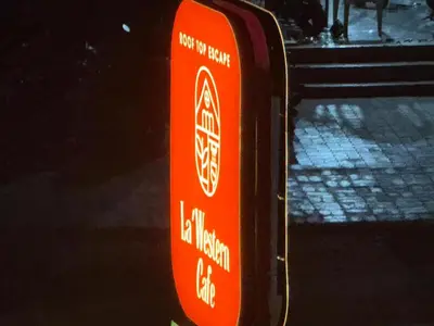 an orange sign on the side of a street at Western Castle Stay n lawn in Coimbatore