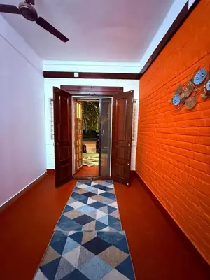 an empty hallway with a door and a checkered floor at Western Castle Stay n lawn in Coimbatore