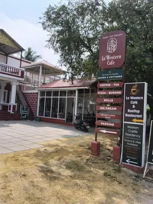 a sign in front of a building at Western Castle Stay n lawn in Coimbatore