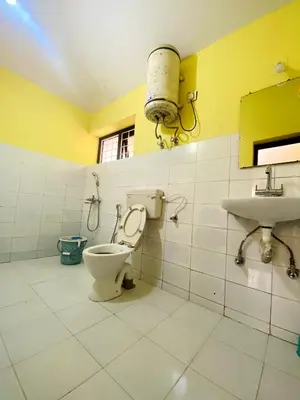 a bathroom with a toilet and a sink at Skyline Haven cottage ll in Ooty