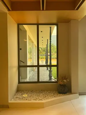 a room with a large window in a building at Hotel Aarka in Mettuppālaiyam