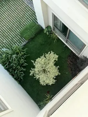 an overhead view of a garden with a white plant at Hotel Aarka in Mettuppālaiyam