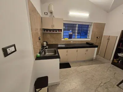 a small kitchen with a sink and a window at The Brook by Turquoise Villas in Kodaikānāl