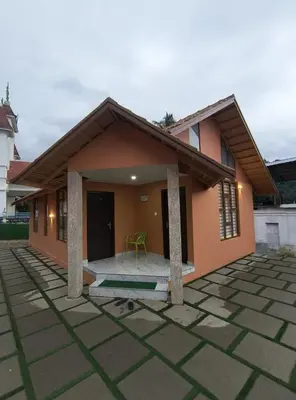 a small house with a patio in front of it at Mystic Rock Staycations in Mannārakkāt