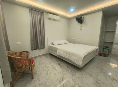 a bedroom with a bed and a chair in it at Mystic Rock Staycations in Mannārakkāt