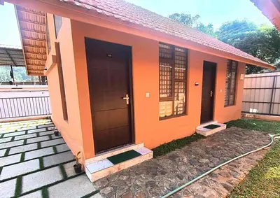 a small house with an orange at Mystic Rock Staycations in Mannārakkāt
