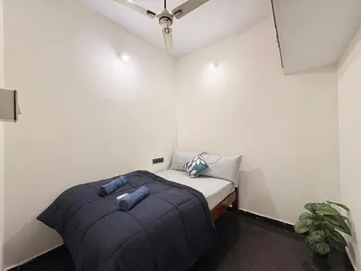 a small bedroom with a bed and a ceiling at Kamadhenu Homestay, Comapact 2BHK OPP Mysore zoo B in Mysore