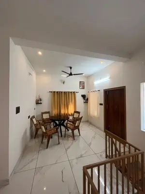 a dining room with a table and chairs at Idachirakkal homestay in Palghat
