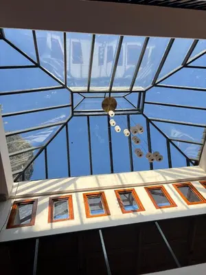 a glass ceiling with windows in a building at Burnside Cottage in Kotagiri