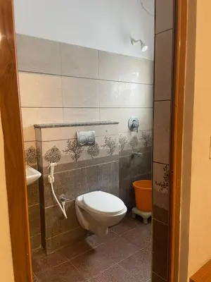a bathroom with a toilet and a sink at AAKI Comforts in Mysore