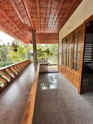 a room with a wooden floor and a wooden ceiling at Avocado Orchards - Home Stay in Kenichira
