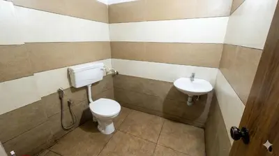 a bathroom with a toilet and a sink at SAIS LINE Residency in Kozhikode