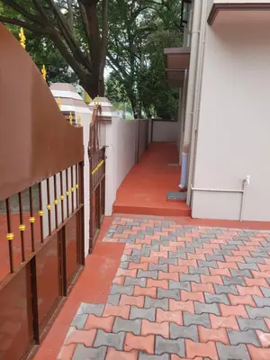 a fence on the side of a house at Sri Kamakshi Amman Home Stay in Tudiyalūr