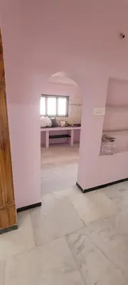an empty room with a white wall and a window at Sri Kamakshi Amman Home Stay in Tudiyalūr