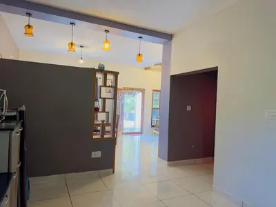 a living room with a dark wall and a hallway at WhiteLilys Pool Retreat Kaggodlu Madikeri Coorg in Madikeri