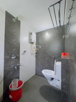 a bathroom with a white toilet and a shower at WhiteLilys Pool Retreat Kaggodlu Madikeri Coorg in Madikeri