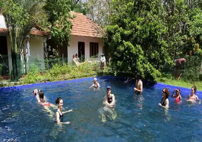 a group of people swimming in a swimming pool at Tranquilandia in Varagampadi