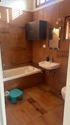 a bathroom with a tub and a sink and a toilet at Aalaya in Mysore