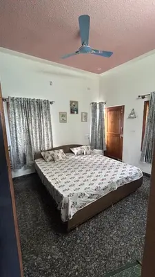 a bedroom with a large bed with a ceiling at Aalaya in Mysore