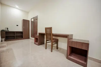 a room with a desk and a chair in it at Kayalresidency in Gopichettipālaiyam