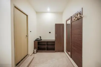 a hallway with a door and a desk in a room at Kayalresidency in Gopichettipālaiyam