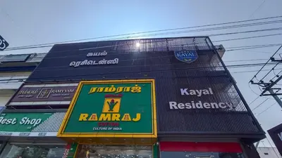 a building with signs on the side of it at Kayalresidency in Gopichettipālaiyam
