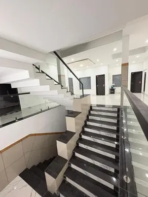 a staircase in a building with black and white stairs at Zeekka Tourist Home in Meenangadi