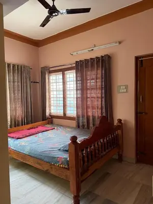 a bedroom with a large bed in a room at Cheerful - homes Mysore stay in Mysore