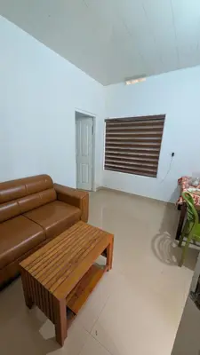 a living room with a brown couch and a coffee table at Vihara Inn Resort in Vayittiri
