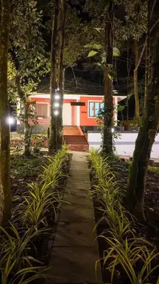 a path in a garden with a house in the background at Vihara Inn Resort in Vayittiri