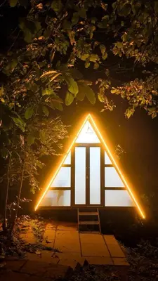 a small house with lights on the side of it at Vihara Inn Resort in Vayittiri