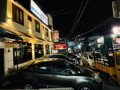 a car parked on a city street at night at budget stay-mystique inn in Ooty