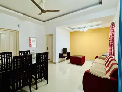 a living room with a couch and a table at Anandha Vibes STAY blessed in Guruvāyūr